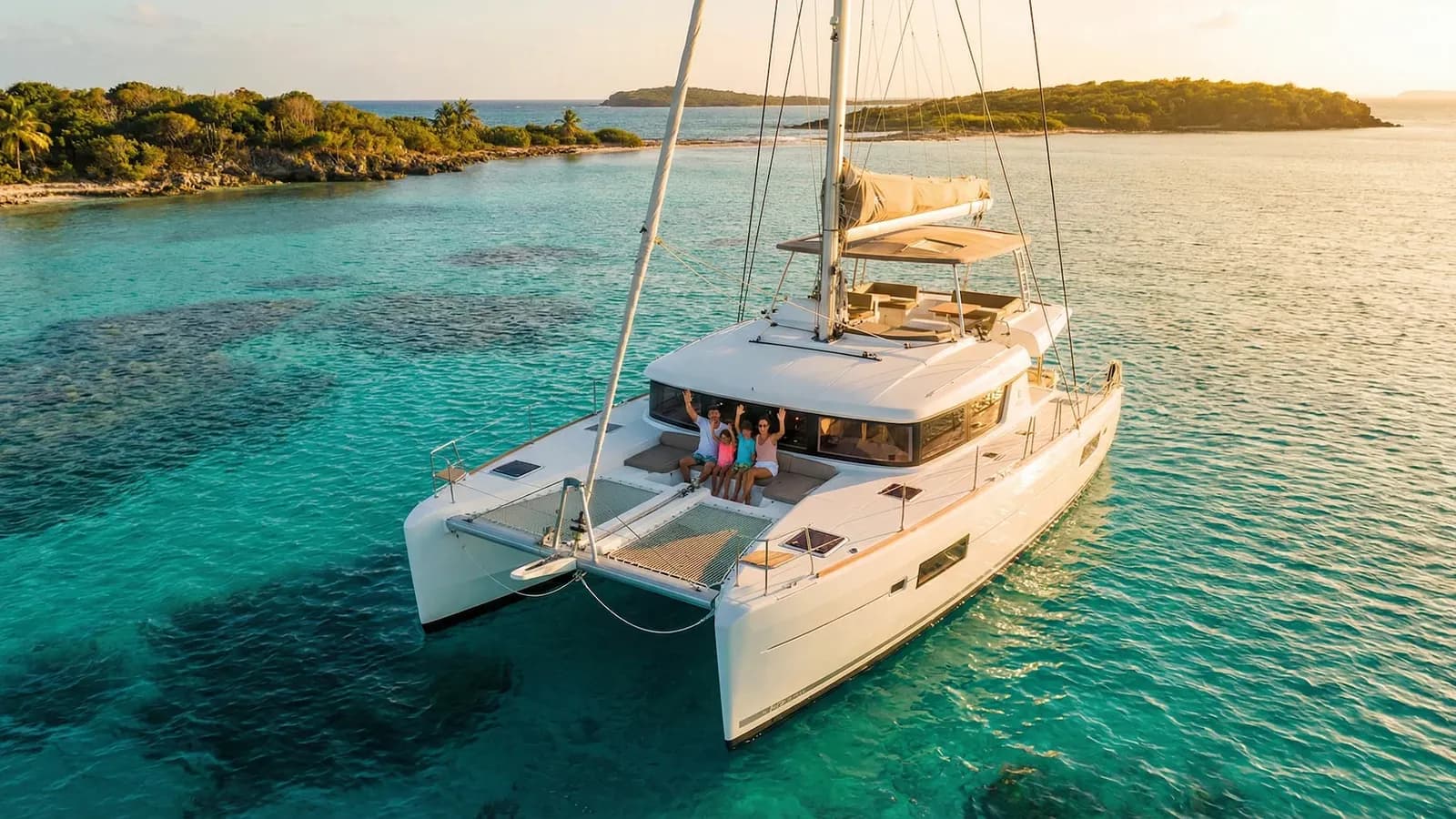 A catamaran at anchor in clear turquoise water