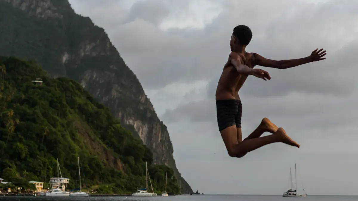 Jumping into the water below the Pitons, St. Lucia