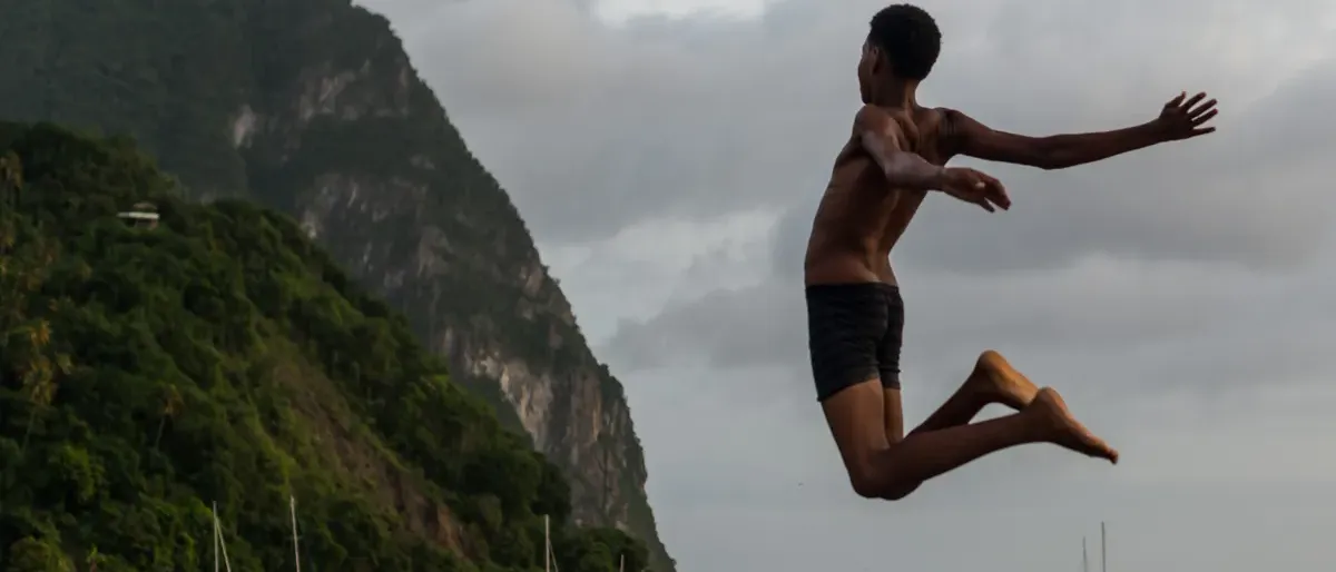 Jumping into the water below the Pitons, St. Lucia