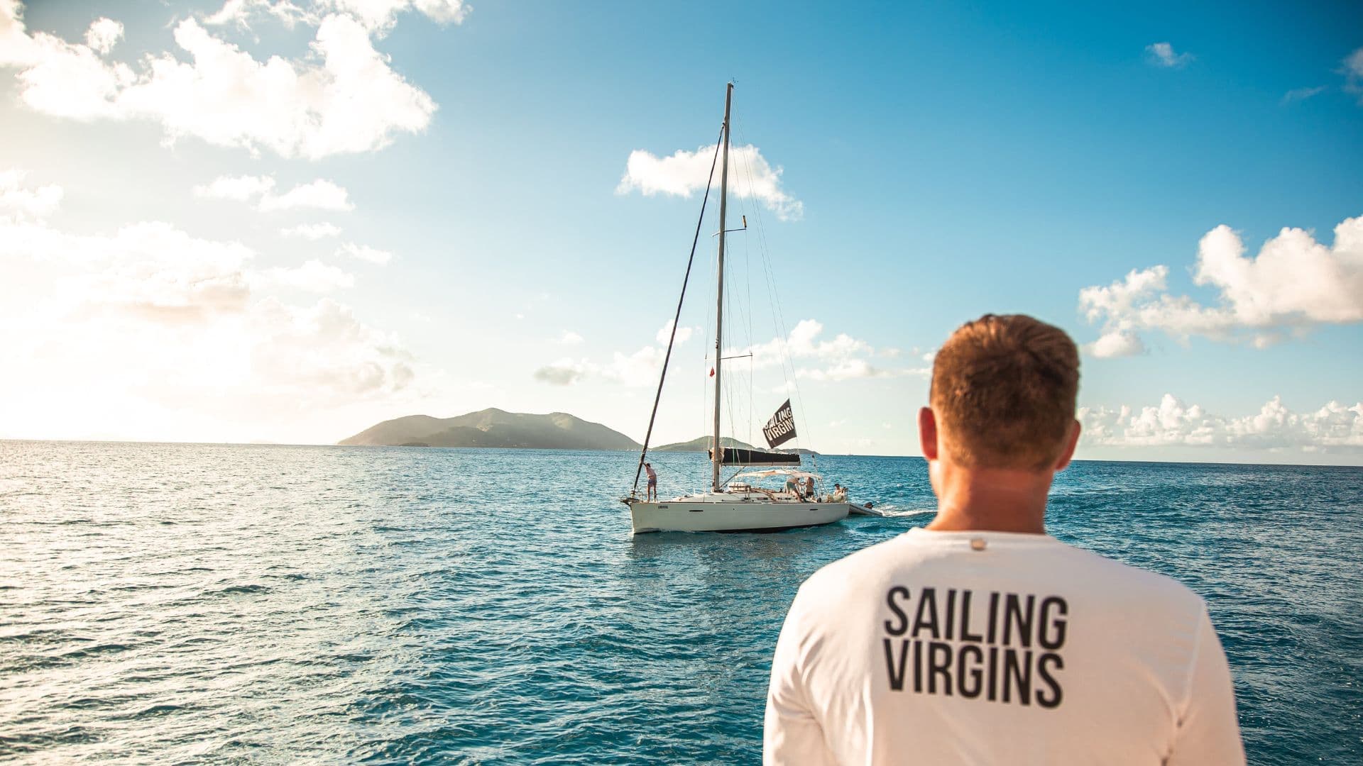 Yacht sailing at sunset with experienced crew handling advanced maneuvers